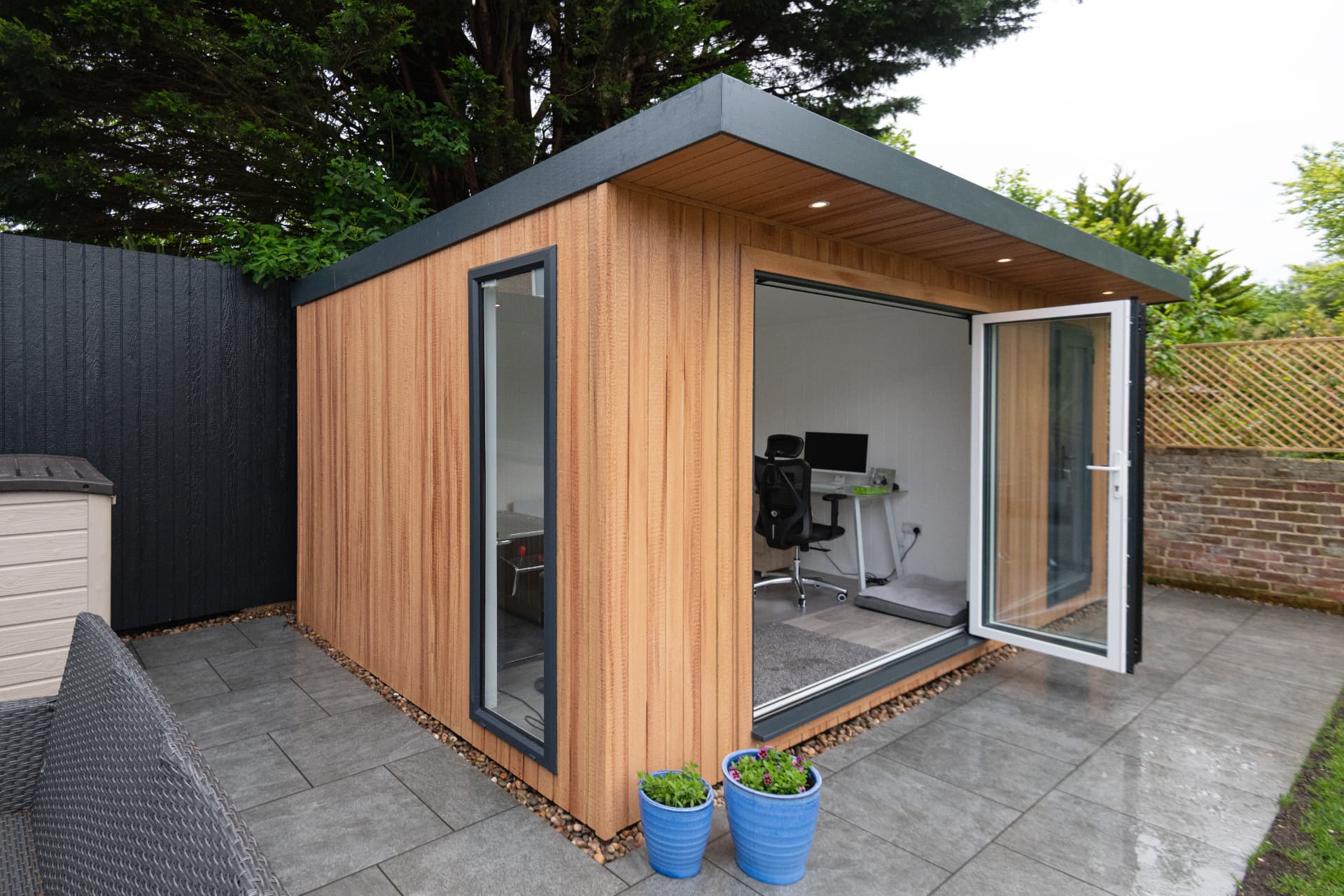 Cedar garden room used as a home office with desk and chair