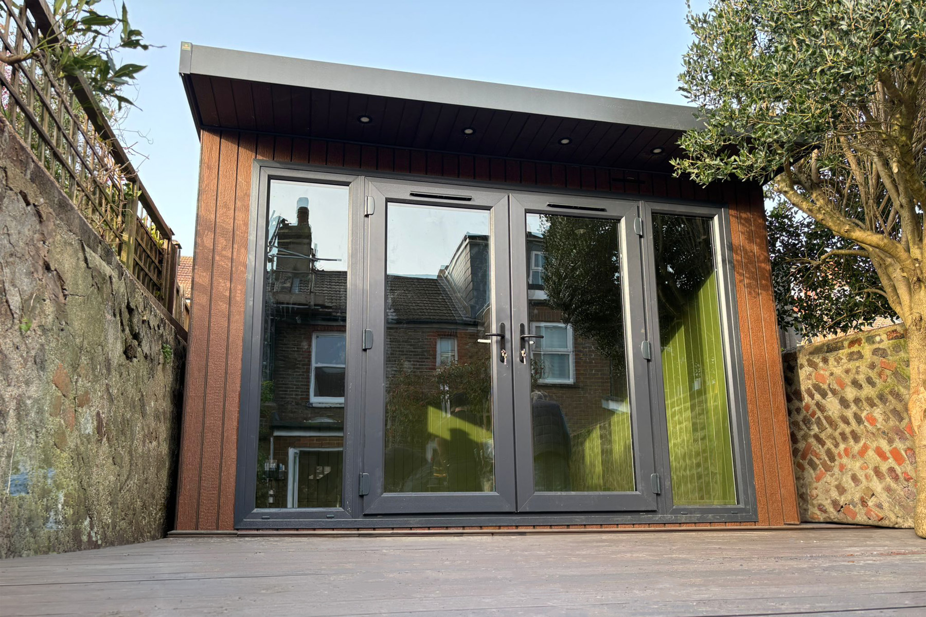 3.6m x 3.8m Signature SIPs garden room in Weathered Oak ToughWood with bifold doors