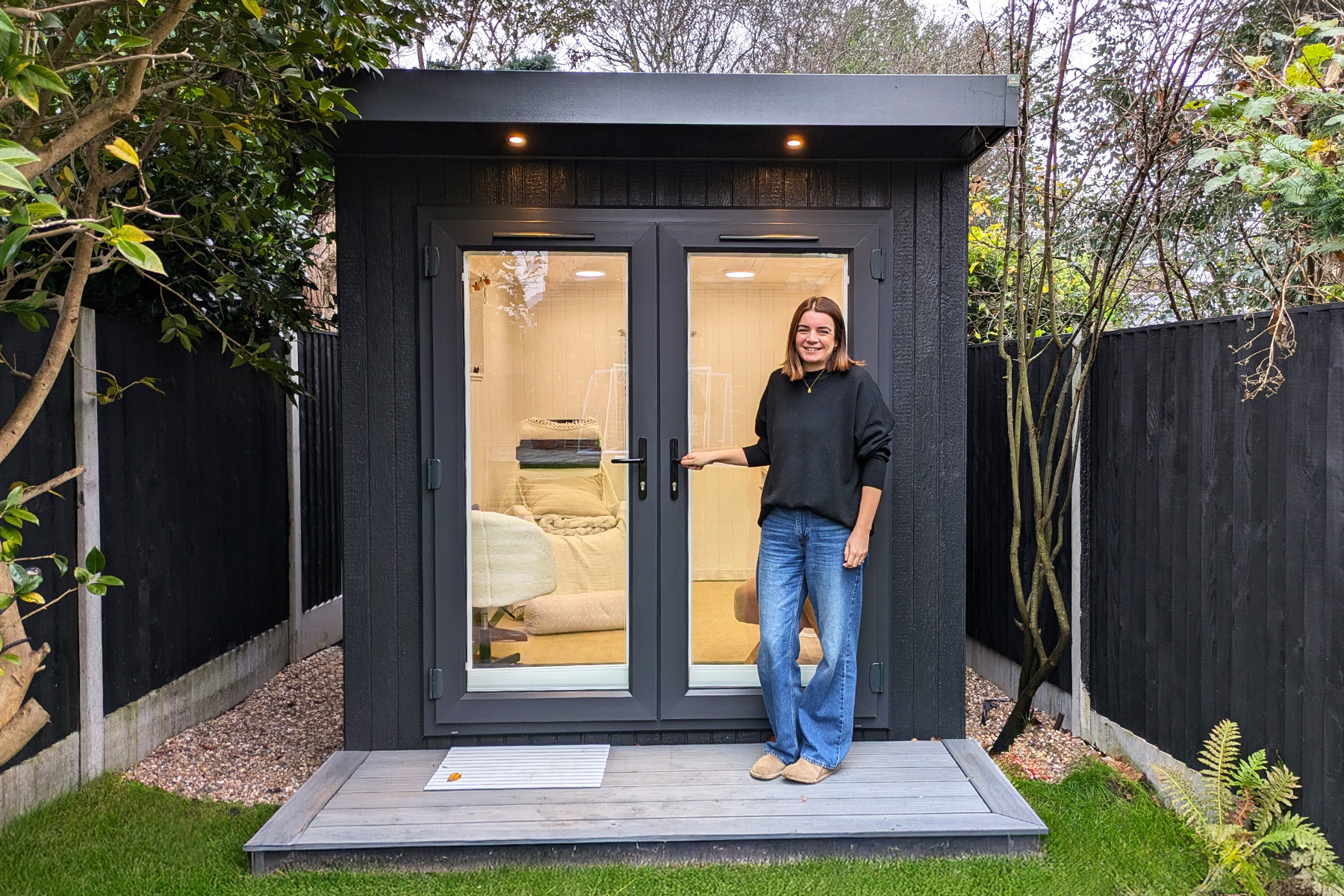 Compact Granite ToughWood garden room with French doors and warm interior lighting