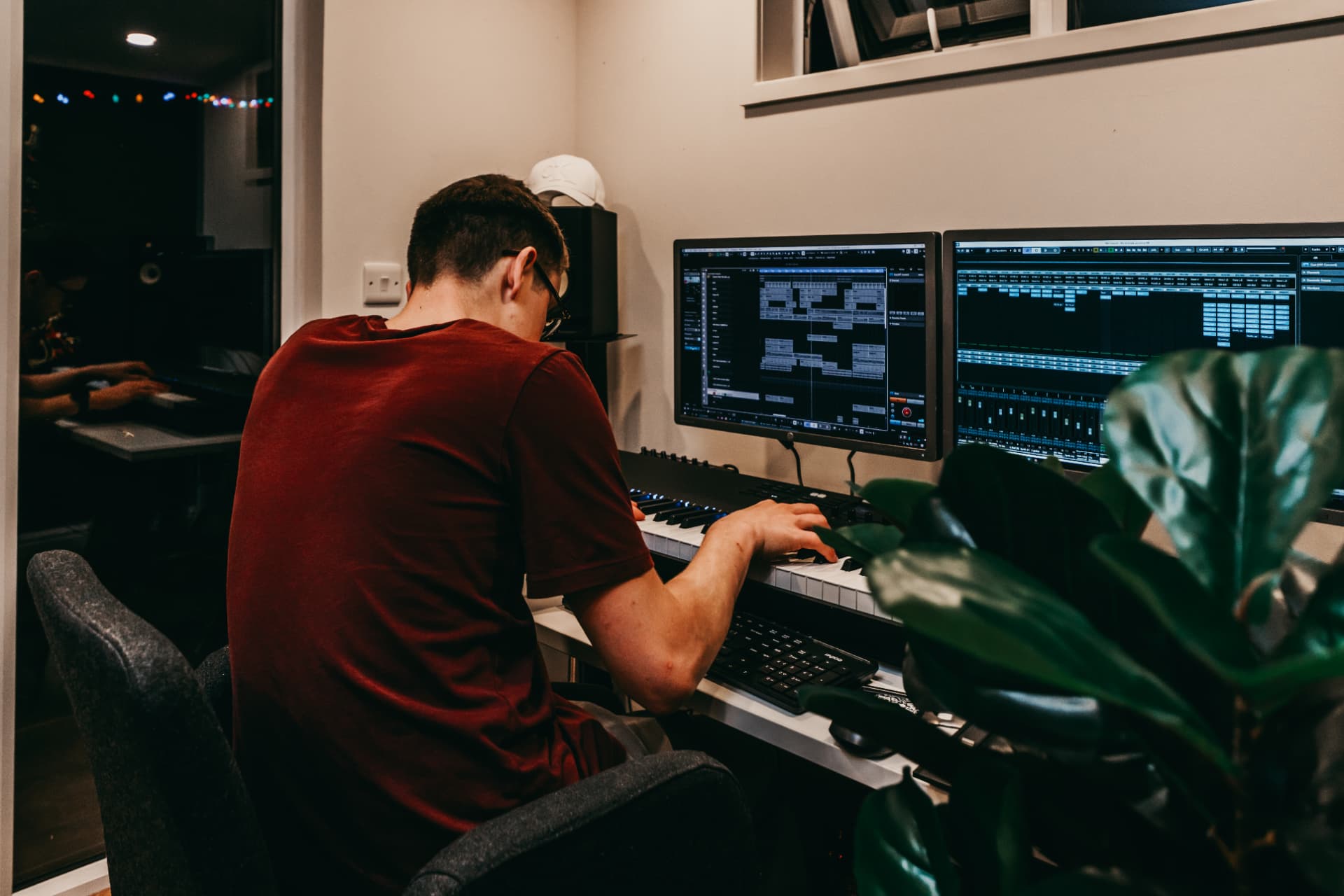 Music producer working on a track at a garden studio workstation