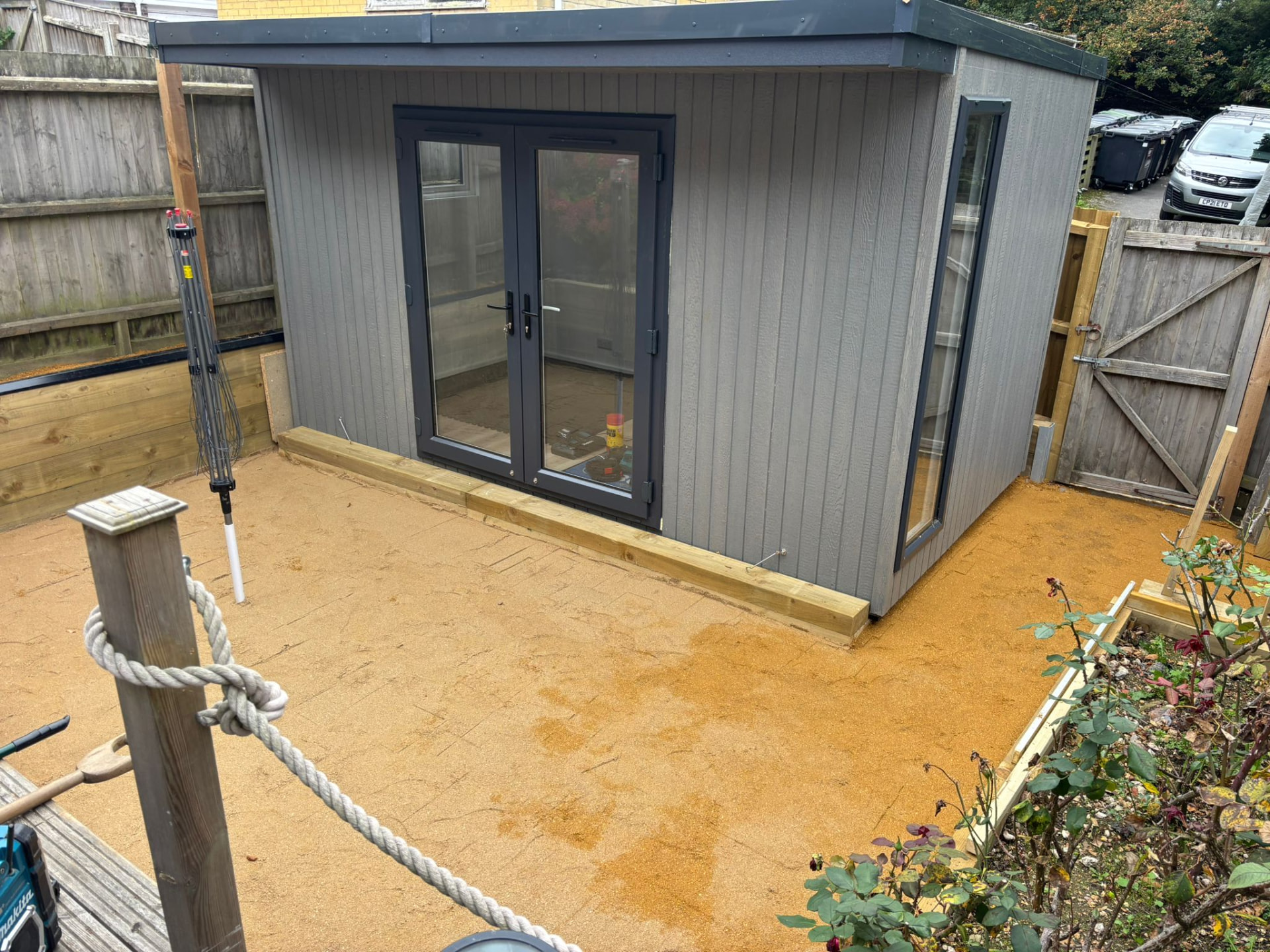 Compact Mountain Ash ToughWood garden room newly installed on a resin patio
