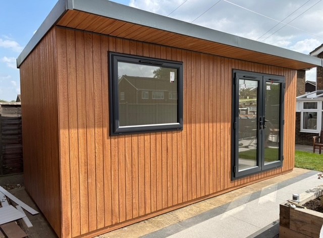 Side view of a Cedar ToughWood garden room with a large picture window