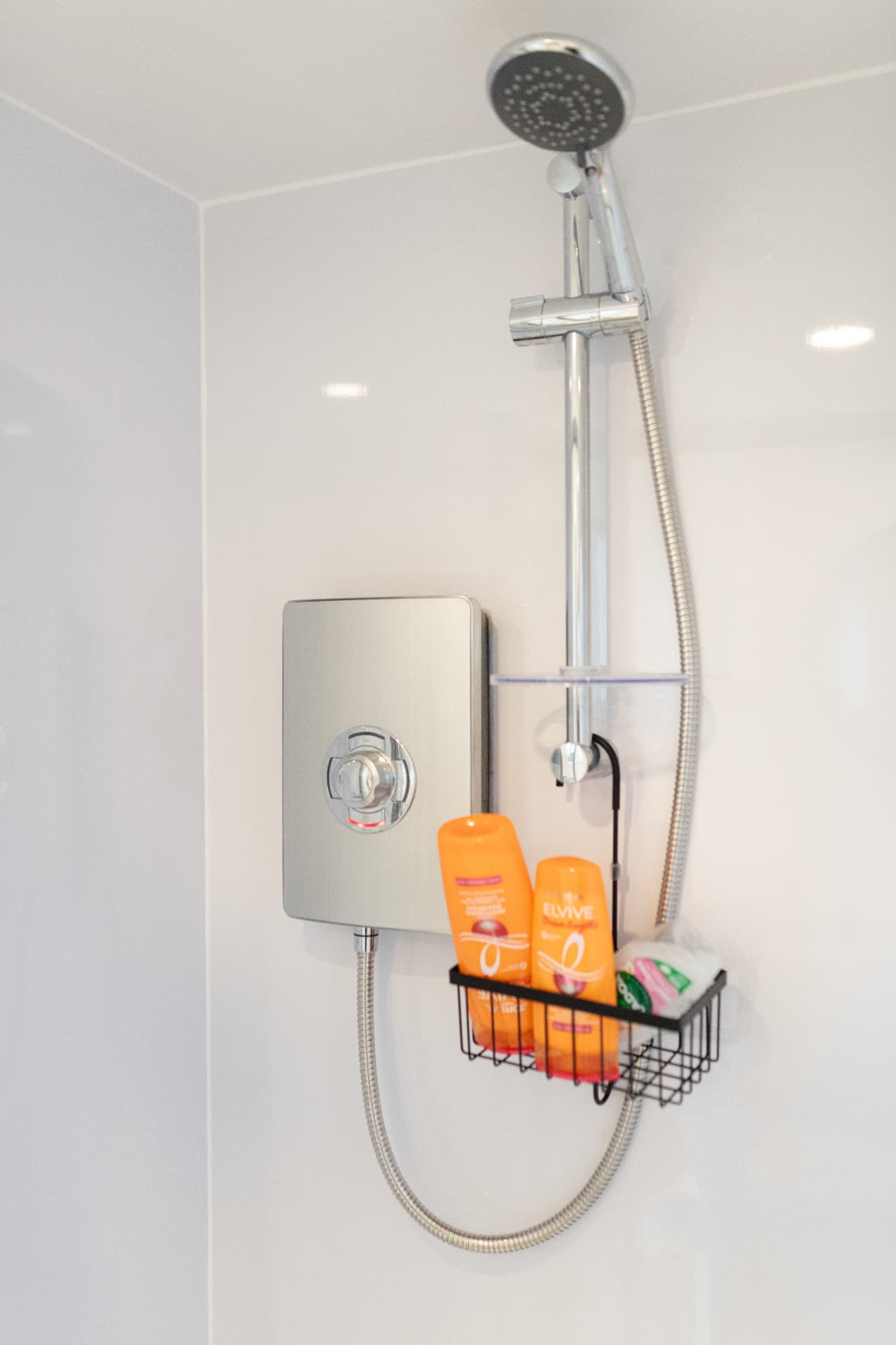 Electric shower fitted in a garden room shower cubicle