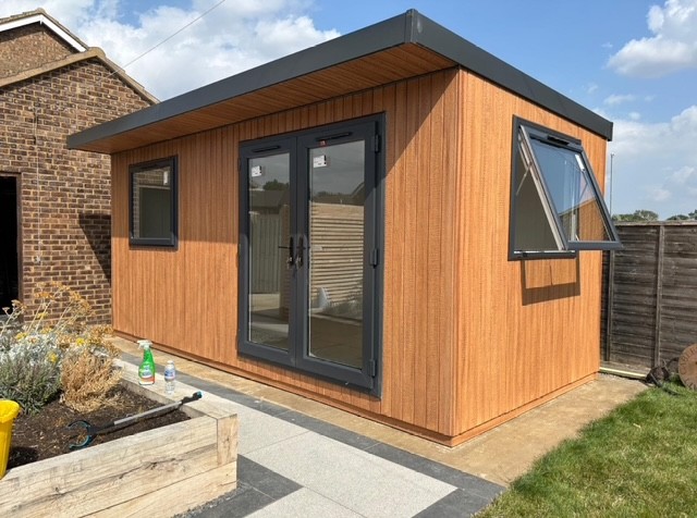 Cedar ToughWood garden room with anthracite French doors and an opening window