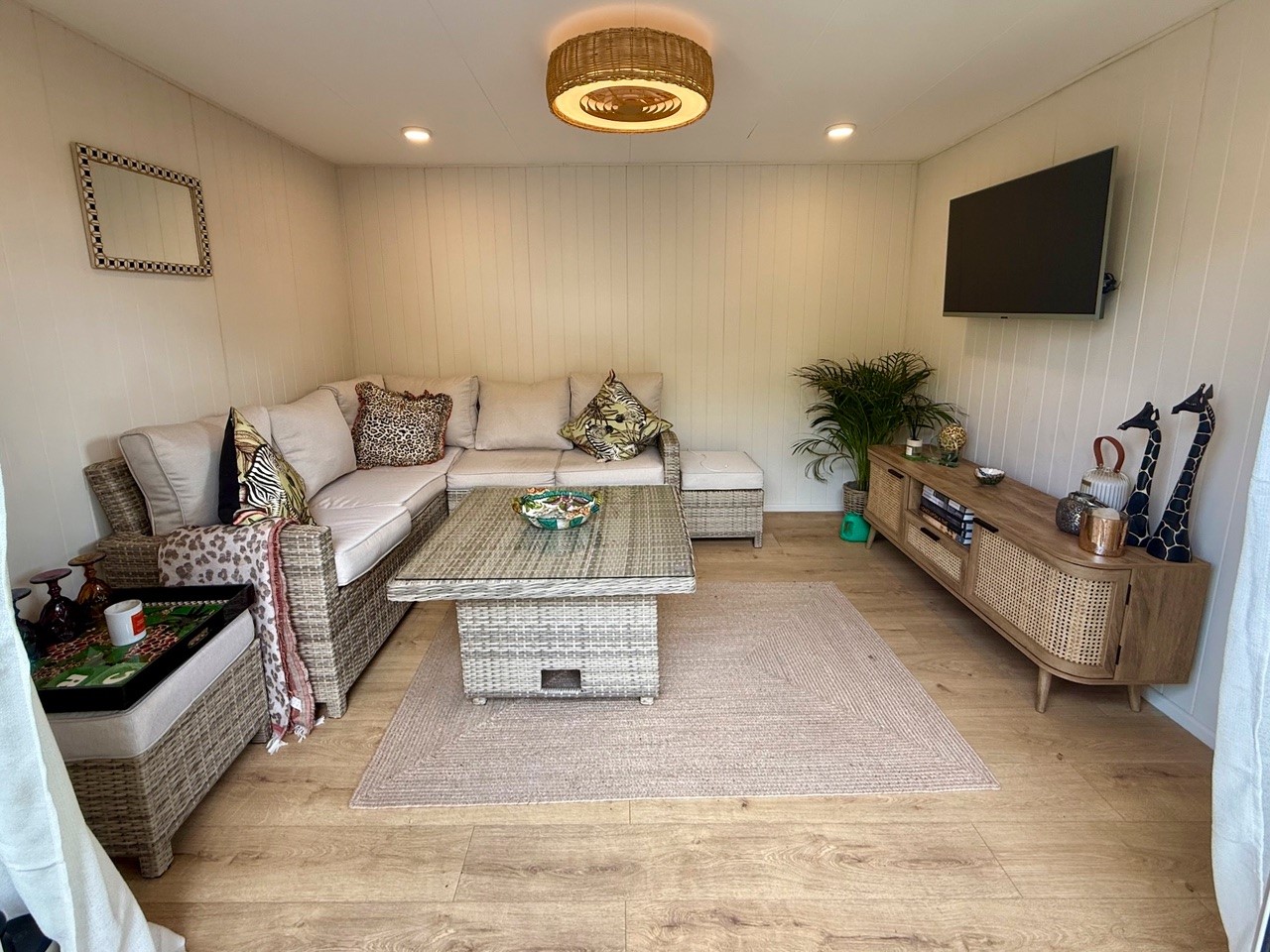 Silver Birch ToughWood garden room interior furnished as a snug with corner sofa and TV