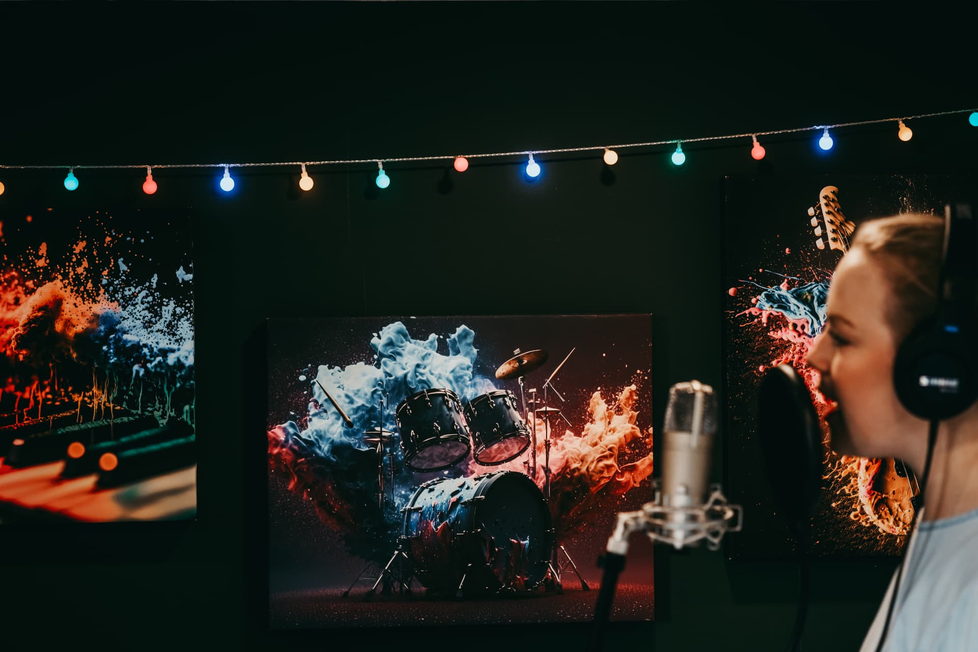 Singer at a condenser microphone in a garden recording studio with festoon lights