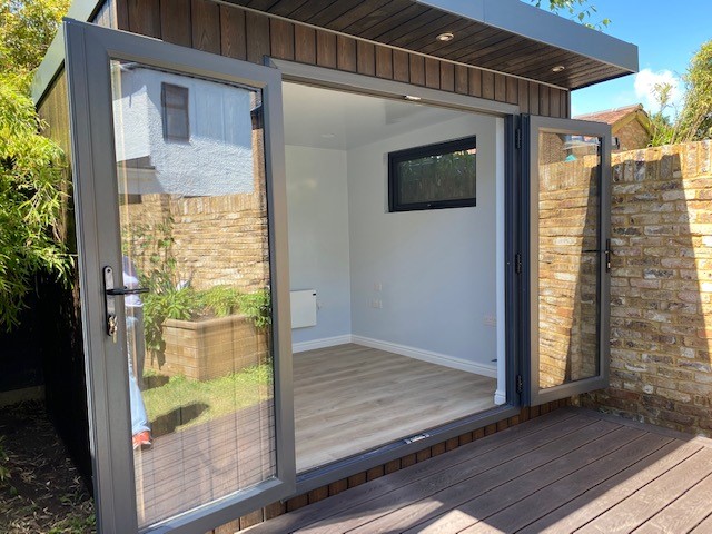 Braemore garden room with bifold doors open onto a deck
