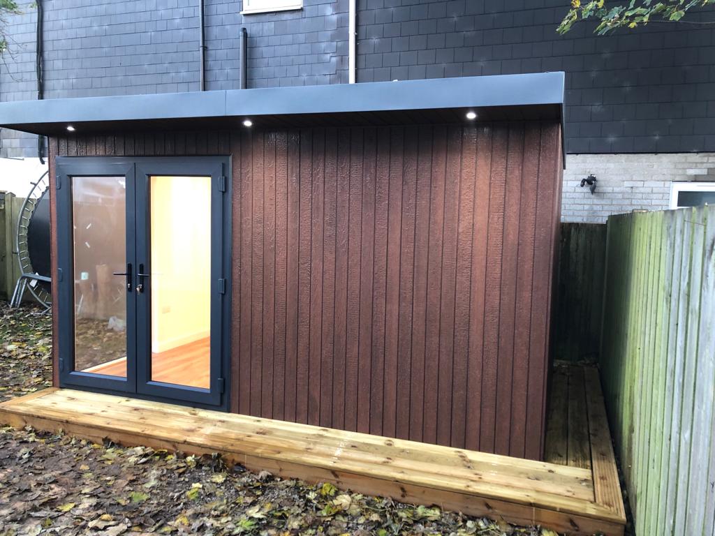 Troughwood clad garden room with anthracite French doors and roof downlights