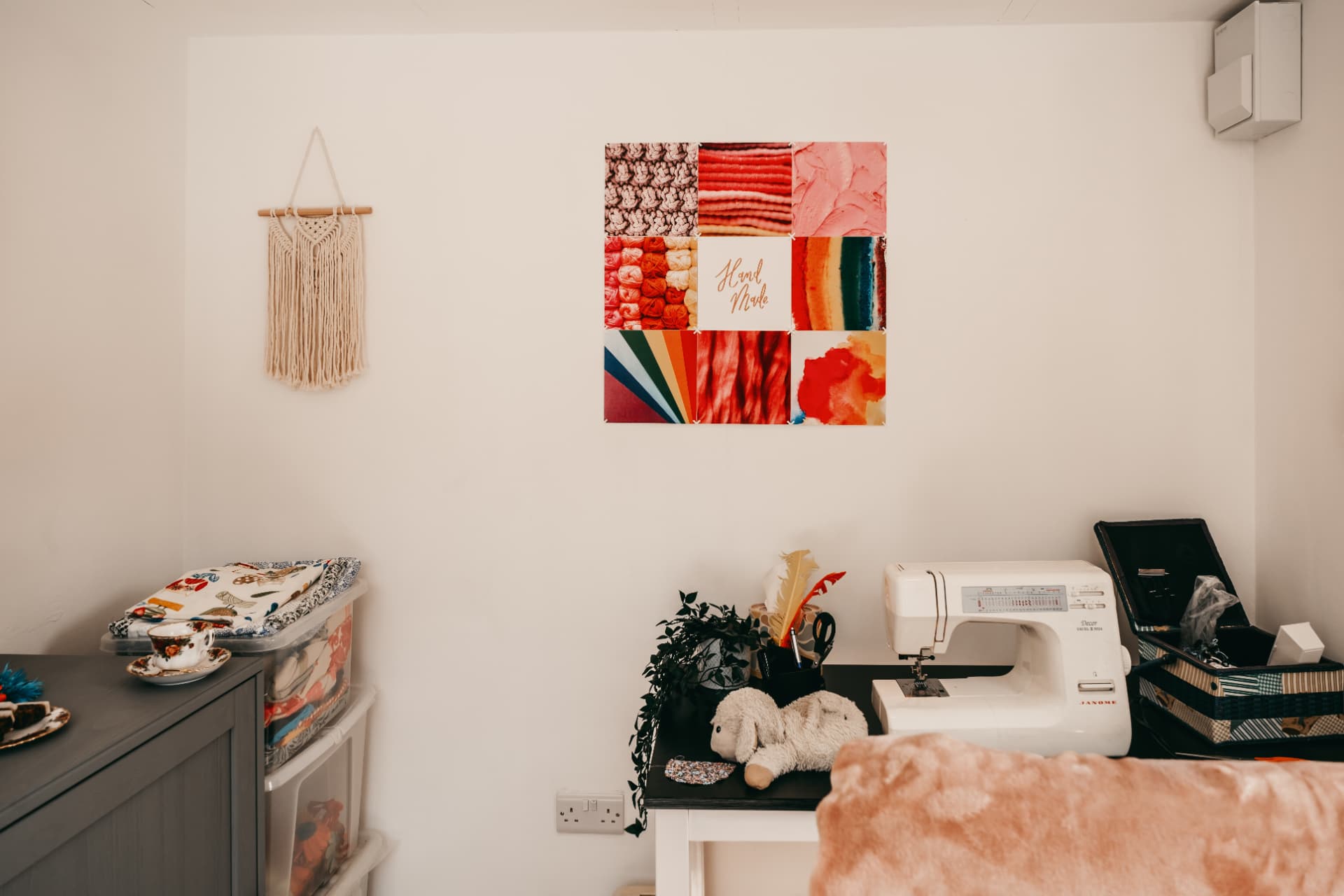 Craft room corner with a sewing machine, fabric storage and handmade wall art